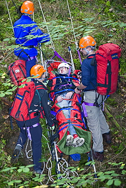 Members of the Langdale Ambleside Mountain Rescue Team treat an injured walker in the Lake District, Cumbria, England, United Kingdom, Europe