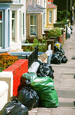 Rubbish on the street awaiting collection, England, United Kingdom, Europe