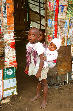 An African child carrying a baby in Mombasa, Kenya, East Africa, Africa