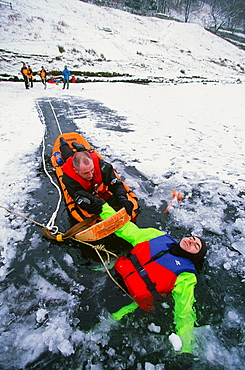 Members of the Langdale Ambleside Mountain Rescue Team rescue a man fallen through ice on Rydal Water in the Lake District National Park, Cumbria, England, United Kingdom, Europe