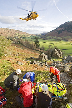 Members of Langdale Ambleside Mountain Rescue Team treat a seriously injured climber with a broken femur in the Langdale Valley, Lake District, Cumbria, England, United Kingdom, Europe