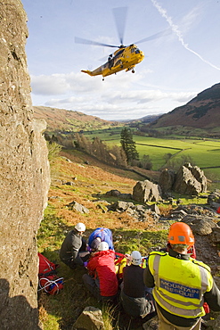 Members of Langdale Ambleside Mountain Rescue Team treat a seriously injured climber with a broken femur in the Langdale Valley, Lake District, Cumbria, England, United Kingdom, Europe