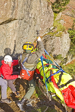 An RAF Sea King helicopter evacuates a seriuosly injured climber with a broken femur from a mountain rescue site in the Langdale Valley, Lake District, England, United Kingdom, Europe