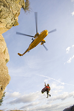 An RAF Sea King helicopter evacuates a seriuosly injured climber with a broken femur from a mountain rescue site in the Langdale Valley, Lake District, England, United Kingdom, Europe