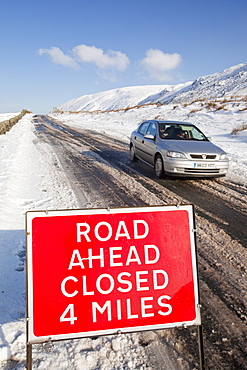 A road closed sign on top of Kirkstone Pass in winter, Lake District, Cumbria, England, United Kingdom, Europe