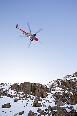 A Navy Sea King helicopter lowers a stretcher to evacuate a seriously injured walker who had fallen 250 feet on Bow Fell in the Lake District, Cumbria, England, United Kingdom, Europe