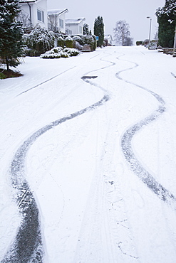 Skid marks in the snow from a car on a steep road in Ambleside, Lake District, Cumbria, England, United Kingdom, Europe