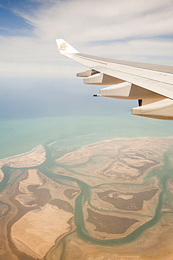 A plane flying over the coastline of Dubai, United Arab Emirates, Middle East