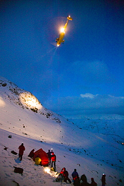 An RAF Sea King Helciopter arrives on scene as Mountain rescue team members rescue a seriously injured women from Red Screes who had fallen aorund 300 feet in the snow, Lake District, Cumbria, England, United Kingdom, Europe