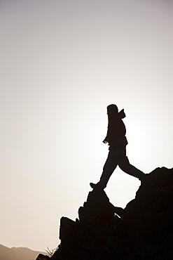 A climber on a ridge above Chapel Stile in the Langdale Valley in the Lake District, Cumbria, England, United Kingdom, Europe