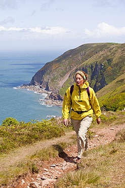 A woman on the South West coast Path near Combe Martin in Devon, England, United Kingdom, Europe