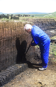 A man harvesting peat for fuel on the Isle of Skye, Scotland, United Kingdom, Europe