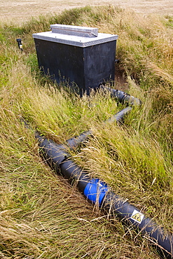 An old rubbish tip where the methane escaping from the decomposing rubbish is being captured and burnt, Walney Island, Cumbria, England, United Kingdom, Europe