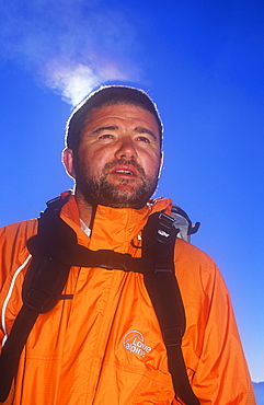 A man's breath highlighted by sunlight in cold air, United Kingdom, Europe