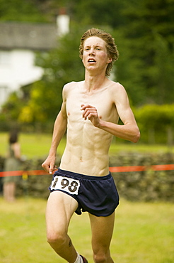 A fell runner competing in a fell race in the Lake District, Cumbria, England, United Kingdom, Europe