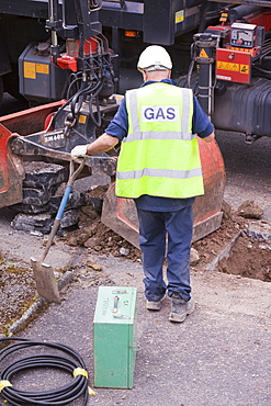 British Gas workers replacing old metal gas pipes with plastic ones as part of an upgrade to comply with modern health and safety legislation, in Ambleside, Cumbria, England, United Kingdom, Europe