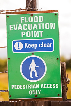 A flood evacuation sign on a caravan park in Towyn, which is very susceptible to coastal flooding, Wales, United Kingdom, Europe