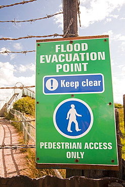 A flood evacuation sign in a caravan park in Kinmel bay that is susceptible to coastal flooding, Wales, United Kingdom, Europe