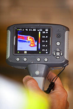 A thermal imaging camera shows heat loss from a hot water pipe, United Kingdom, Europe