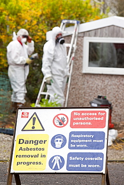 A specialist asbestos removal company removing asbestos from a shed roof in Ambleside, Cumbria England, United Kingdom, Europe