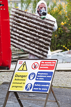 A specialist asbestos removal company removing asbestos from a shed roof in Ambleside, Cumbria England, United Kingdom, Europe