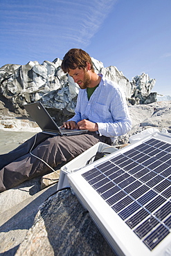 PhD scientist Ian Bartholomew taking measurements as part of a study to measure the speed of the Russell Glacier near Kangerlussuaq, Greenland, Polar Regions