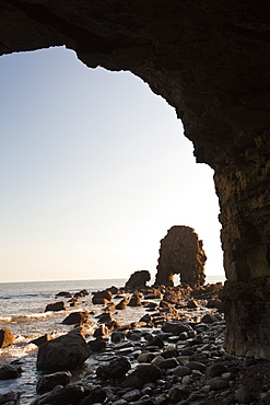 Sea stacks and sea arch seen from a sea cave on the North East coast at Whitburn, between Newcastle and Sunderland, Tyne and Wear, England, United Kingdom, Europe