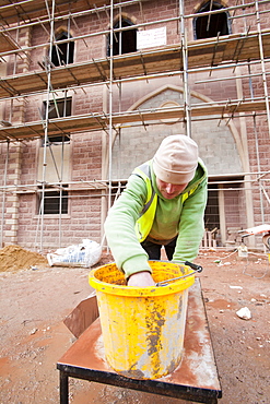 A builder working on a new mosque being built in Keighley, West Yorkshire, Yorkshire, England, United Kingdom, Europe