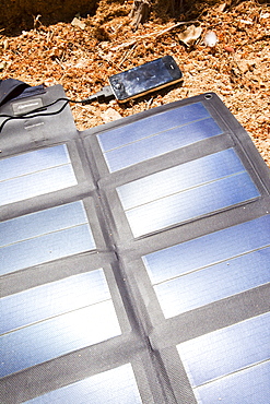 A portable solar mat used to recharge a mobile phone in the Anti Atlas mountains of Morocco, North Africa, Africa