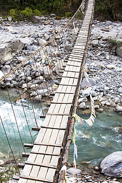 A suspension bridge crossing on the Annapurna Base Camp trek, Himalayas, Nepal, Asia