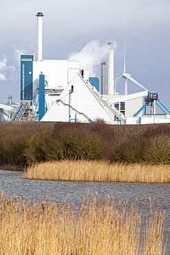 The new biofuel power plant at the Iggesund paper board manufacturer, with wind turbines behind, Workington, Cumbria, England, United Kingdom, Europe