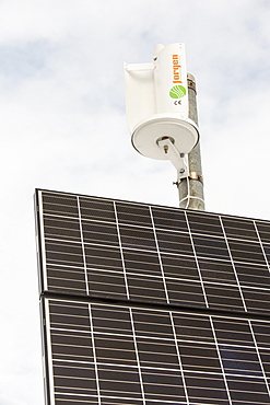 A small vertical axis wind turbine and solar panel on Kirkstone Pass, Lake District, Cumbria, England, United Kingdom, Europe