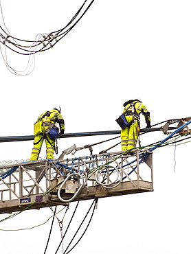 Technicians working to replace old insulators on a pylon in Barrow on Soar, Leicestershire, England, United Kingdom, Europe