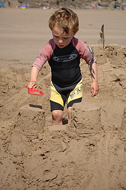 Building sandcastle, Marloes Sands, Pembrokeshire, Wales, UK