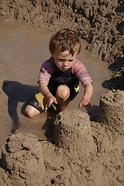 Building sandcastle, Marloes Sands, Pembrokeshire, Wales, UK