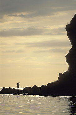 Silhouette of fisherman, Porthlysgi Bay, Pembrokeshire, Wales, UK, Europe        (rr)