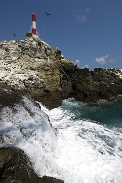 Seawater flowing and lighthouse, St. Peter and St. Paul's rocks, Brazil, South America