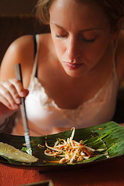 Female, eating, Pad Thai, Khaosan Road.  Bangkok, Thailand, South-East Asia, Asia