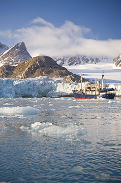 Tourist ship by Glacier face. Longyearbyne, Svalbard, Norway