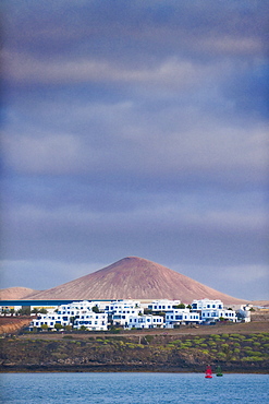 Spain, EspaÃ±a, Canary Islands, Canarias, Lanzarote, Arrecife, Volcanic Landscape with buildings.. Arrecife, Arrceife Harbour, Lanzarote. Canary Islands,  Spain, EspaÃ±a