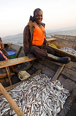 Fisherman on Lake Tanganyika early morning fishing for cichlids to sell in the local fish market, Zambia, Africa