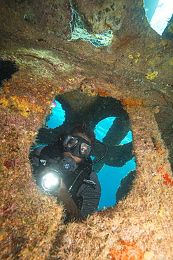 Diver diving on ship wreck in the Turks and Caicos Islands, West Indies, Central America