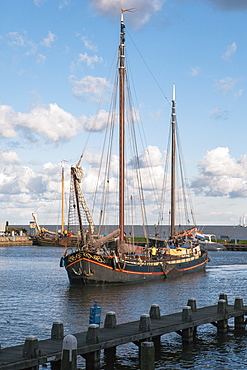 Traditional Dutch merchant ship sailing into Volendam harbour, North Holland Province, The Netherlands (Holland), Europe