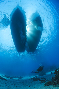 Silhouette of moored dive boats with scuba diver swimming underneath, underwater view, Red Sea, Egypt, North Africa, Africa