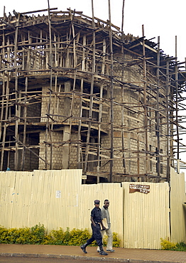 On a building site in Kigali City, an elaborate lattice of wooden planks create the scaffolding on the exterior of the building. Kigali, Rwanda, East Africa