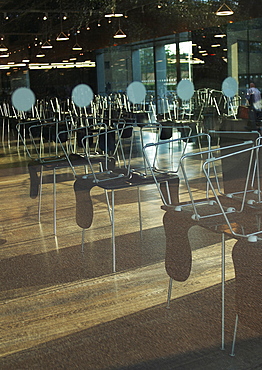 Chairs are stacked on the tables of the ultra modern Cafe 2 at the Tate Modern, London. London, England, UK