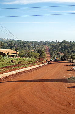 This bright red road clearly shows the type of soil abundant in this area and makes you appreciate why everything has a red hint of colour. Jinja, Uganda, East Africa