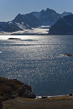 A view across the bay from the towering cliff and glacier in Hornsund (Horn Sound) on the southwestern side of Spitsbergen Island in the Svalbard Archipelago, Barents Sea, Norway.