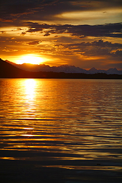 View of the shoreline at sunset from Colt Island in Stephen's Passage of Admiralty Island, Southeast Alaska, USA. Pacific Ocean.