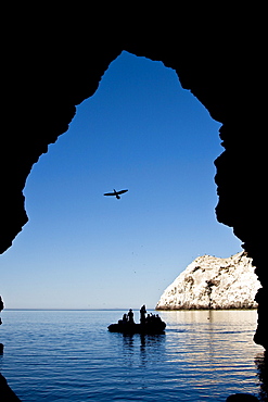 Zodiac approaching a cave at Isla San Pedro Martir in the midriff region of the Gulf of California (Sea of Cortez), Baja California Norte, Mexico. 